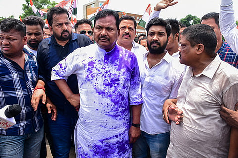 OPCC President Sarat Patnaik stands with supporters at Master Canteen after ink thrown at him inside Congress Bhawan in Bhubaneswar. 