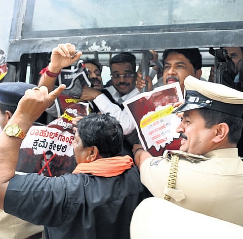 Police detain BJP leaders, including LoP R Ashoka, during the protest in Freedom Park in Bengaluru on Monday  