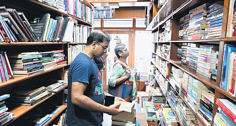 Bibliophiles make one last visit to Nagasri Book House, which will permanently down its shutters on June 8, in Bengaluru on Thursday. (Left) Venkatesh KV and Guruprasad founded the bookstore in November 1976 
