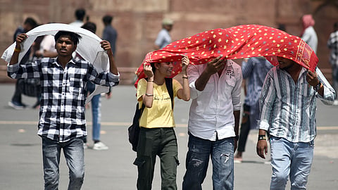 Commuters brave the heat Wave during a hot summer afternoon, as the temperature rises in the Delhi on June 18, 2024 .