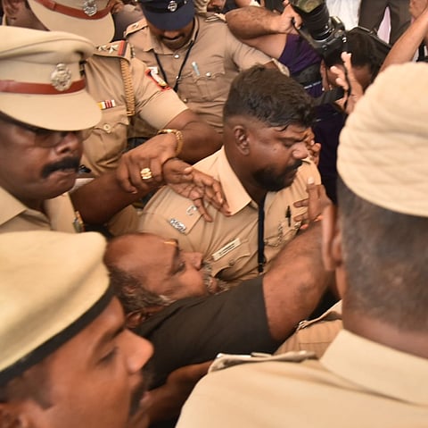 AIADMK  deputy floor leader RB Udayakumar being  evicted by the guards after staging a protest in the well during the assembly session in protest against government in connection with hooch tragedy, on the second day of assembly session on Friday in Chennai.