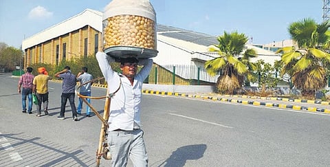 ‘Golgappa’ seller Nanhe Lal goes about his business in Delhi's scorching heat. 