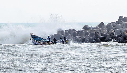 Fishermen braving the rough waves to venture into the sea for fishing at Perumathura Muthalapozhi harbour mouth in Thiruvananthapuram 