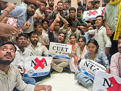 Members of NSUI, Congress's students wing, raise slogans during their protest over the alleged rigging of the NEET UG exams. 
