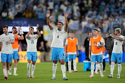 Uruguay's Ronald Araujo, center, and teammates celebrate their team's 5-0 victory over Bolivia at the end of a Copa America Group C soccer match in East Rutherford, N.J., Thursday, June 27, 2024.