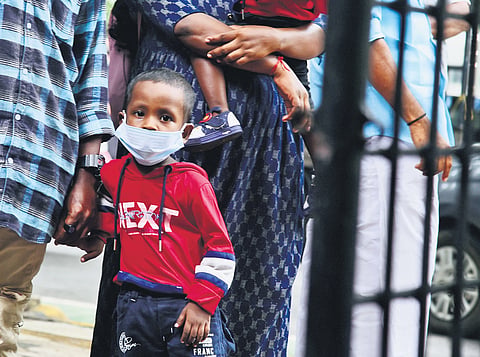 A child stands in a queue at the OP department of the Ernakulam GH. Since the onset of monsoon, viral fever cases have gone up in the state 