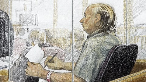 This artist’s sketch shows accused serial killer Robert Pickton taking notes during the second day of his trial in B.C. Supreme Court in New Westminster, British Columbia, Jan. 31, 2006. 
