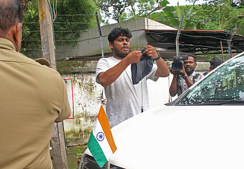 A KSU activist ties a black flag on General Education Minister V Sivankutty’s car outside his official residence, Rose House, in Thiruvananthapuram on Sunday. 