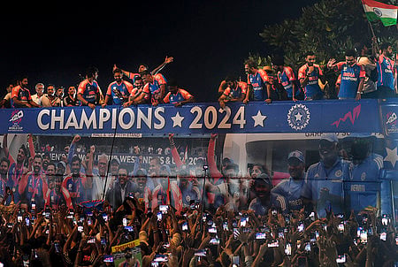 Mumbai: Players of the T20 World Cup-winning Indian cricket team with the championship trophy acknowledge fans during their open bus victory parade