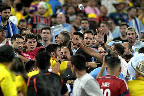 Colombia's supporters (L) clash with Uruguay's supporters at the end of the Conmebol 2024 Copa America tournament semi-final football match between Uruguay and Colombia on July 10, 2024. 