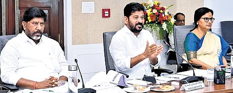Chief Minister A Revanth Reddy addresses the collectors conference on Tuesday, along with Deputy Chief Minister Mallu Bhatti Vikramarka and Chief Secretary Santhi Kumari.  