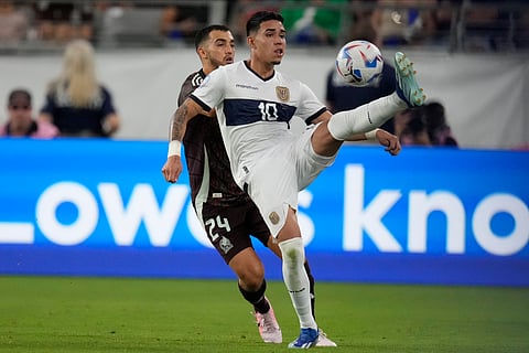 Ecuador's Kendry Paez, front, and Mexico's Luis Chavez vie for the ball during a Copa America match