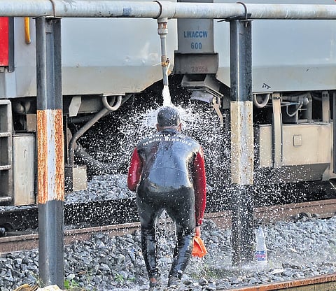 A scuba diver with the fire force washes his head at the Thiruvananthapuram railway station after the search operation at Amayizhanchan canal on Sunday. 