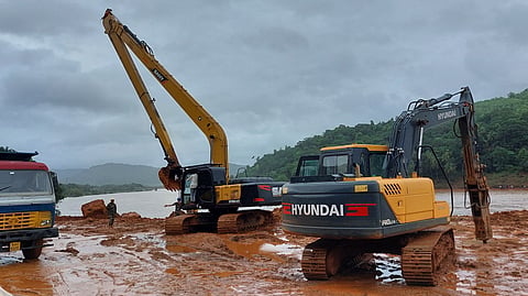 Boom excavators searching for the missing truck near the Gangavali river where the landslide occurred.
