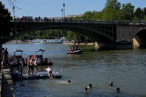 People swim in the Seine river after Mayor Anne Hidalgo swam in the river right before Olympics. 