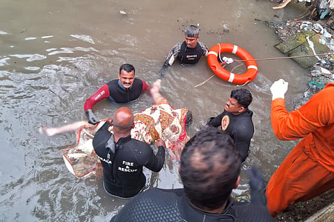 Rescue services personnel retrieve the dead body of Joy, the sanitation worker who went missing in the canal 