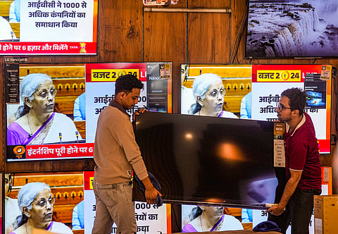 Union Finance Minister Nirmala Sitharaman seen presenting Union Budget 2024-25 on television screens, at a showroom in Mumbai, Monday, July 22, 2024. 