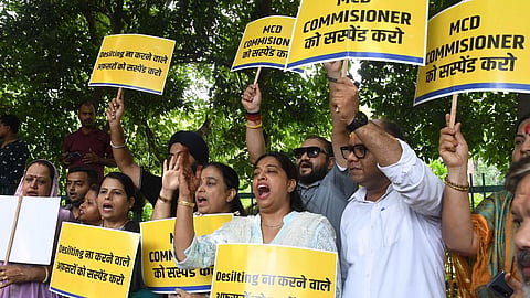 AAP MLAs and councillors held a protest outside the Raj Niwas on Monday to demand the sacking of the MCD commissioner for alleged failure to issue directions for desilting drains.