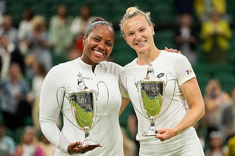 Taylor Townsend and Katerina Siniakova pose with their trophy's after winning the women's doubles final at the Wimbledon 