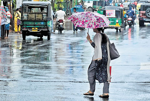 A woman on the streets of Vijaywada during rain on Saturday.