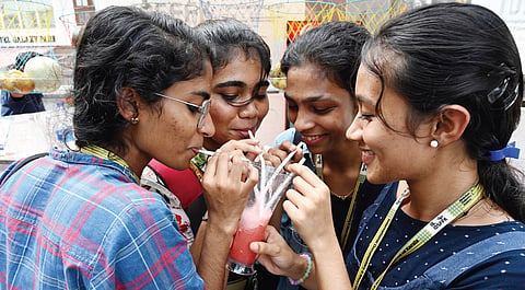 Delegates share juice from a glass at the venue of International Documentary and Short Film Festival of Kerala in Thiruvananthapuram on Saturday