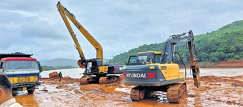 Earthmovers clear the debris at the landslide spot in Shirur 