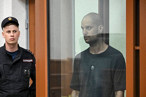US journalist Evan Gershkovich, accused of espionage, stands inside a glass defendants' cage during the verdict announcement (Photo | AFP)