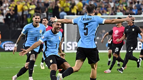 Uruguay's midfielder #05 Manuel Ugarte celebrates after scoring in a penalty shoot-out to win the Conmebol 2024 Copa America tournament quarter-final football match between Uruguay and Brazil on July 6, 2024. 