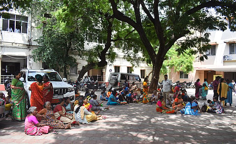 Over 200 people including the sanitary workers who are residing in temporary sheds at Pullukadu staged a dharna in the Coimbatore City Municipal Corporation (CCMC)  