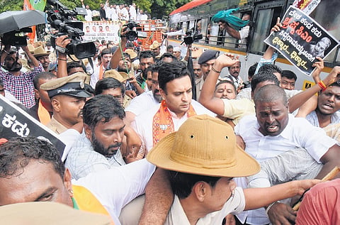 Police detain BJP MP Yaduveer Krishnadatta Chamaraja Wadiyar and party workers as they try to lay seige to MUDA office in Mysuru on Friday 