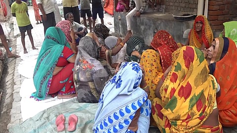 Relatives mourn near the body of a victim a day after a stampede that occured during a 'satsang' (religious congregation), in Sikandra Rao area of Hathras district, Wednesday, July 3, 2024.