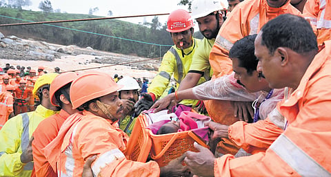 An infant being rescued by the National Disaster Relief Force (NDRF) team from the landslide-affected Mundakkai in Wayanad on Tuesday 