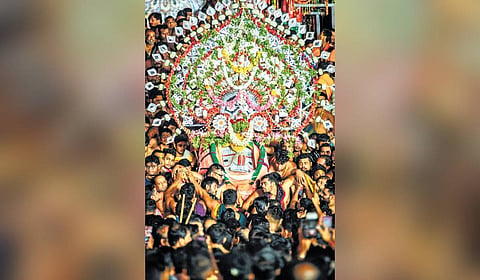 Lord Balabhadra being carried to the temple in pahandi.