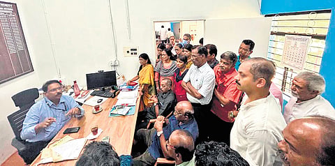 Residents stage protest inside the KWA office at Vellayambalam on Tuesday demanding restoration of water supply 