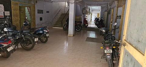 Two-wheelers parked inside the building of the government multi-department complex at Khajamalai 