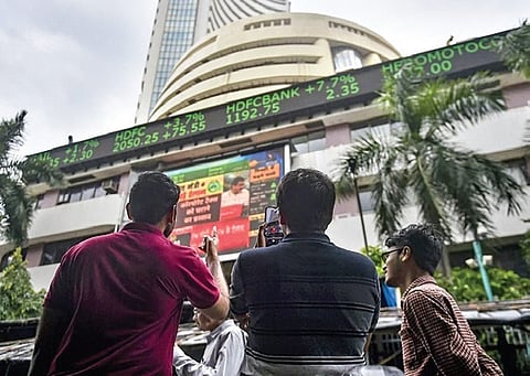 People look at the display screen of the BSE at Dalal Street, Mumbai.  