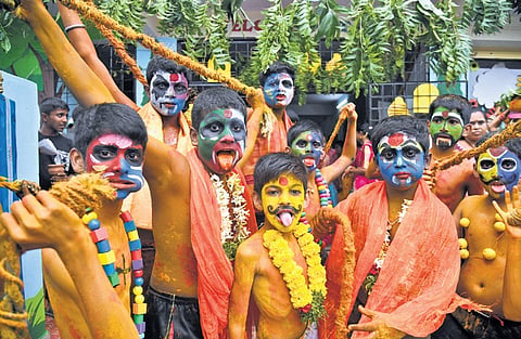 Students dress up as ‘Potharaju’ as part of Bonalu in Nagole on Saturday.