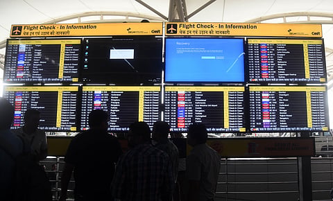 Display screens showing information on flights reflect error messages amid global IT outage