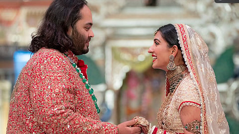 In this photo provided by Reliance Industries, Anant Ambani, left, the son of billionaire Mukesh Ambani, holds hands with Radhika Merchant during their wedding ceremony at Jio World Convention Centre in Mumbai, India, Friday, July 12, 2024.