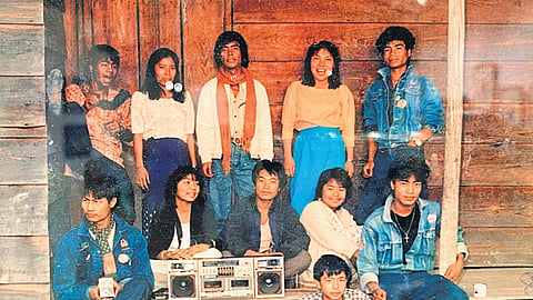 Lamka people posing around a music system
