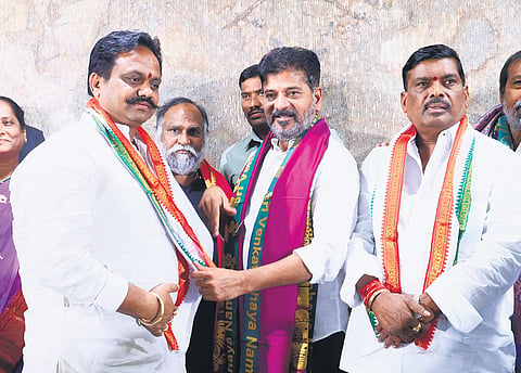 Chief Minister A Revanth Reddy welcomes BRS leader Gali Anil Kumar, left, and Pathancheru MLA Gudem Mahipal Reddy into the Congress fold on Monday