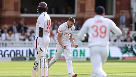 England's Gus Atkinson, center, celebrates taking the wicket of West Indies' Jason Holder on day two of the first Test match between England and West Indies at Lord's Cricket Ground, London, Thursday July 11, 2024. 