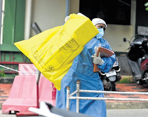 A Kozhikode Medical College Hospital staffer heads to the isolation ward to collect samples from contacts of the Nipah virus victim for testing 