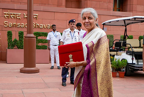 Union Finance Minister Nirmala Sitharaman with a red pouch carrying the Budget documents arrives at the Parliament to present the Union Budget 2024-25, in New Delhi, Tuesday, July 23, 2024.