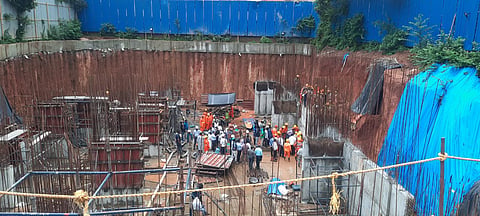 The earth has been vertically excavated for about 20 feet for the foundation of the building.
