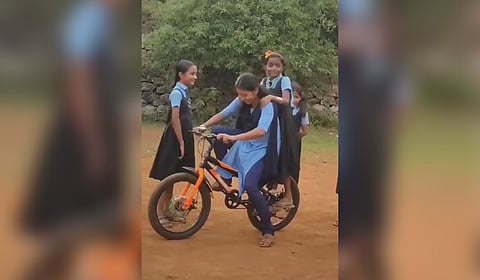 Shalini teacher with her students. A screenshot from the video