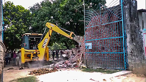 The bakery of Samajwadi Party (SP) leader Moeed Khan, the main accused in the gang rape of a minor girl, is being bulldozed by the administration after it was found to be illegal, in Ayodhya on Saturday. 