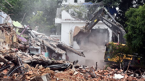 Houses being bulldozed during a demolition drive 