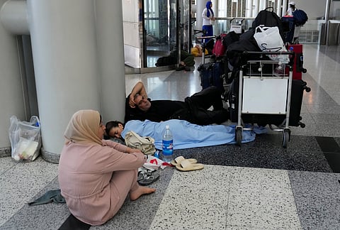 Passengers whose flights were cancelled, wait at the departure terminal ground of Rafik Hariri International Airport, in Beirut, Lebanon, Monday, Monday, Aug. 5, 2024. 