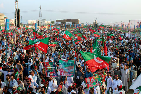 Supporters of imprisoned former Prime Minister Imran Khan take a part in a rally to mark the first anniversary of his arrest and demand his release
